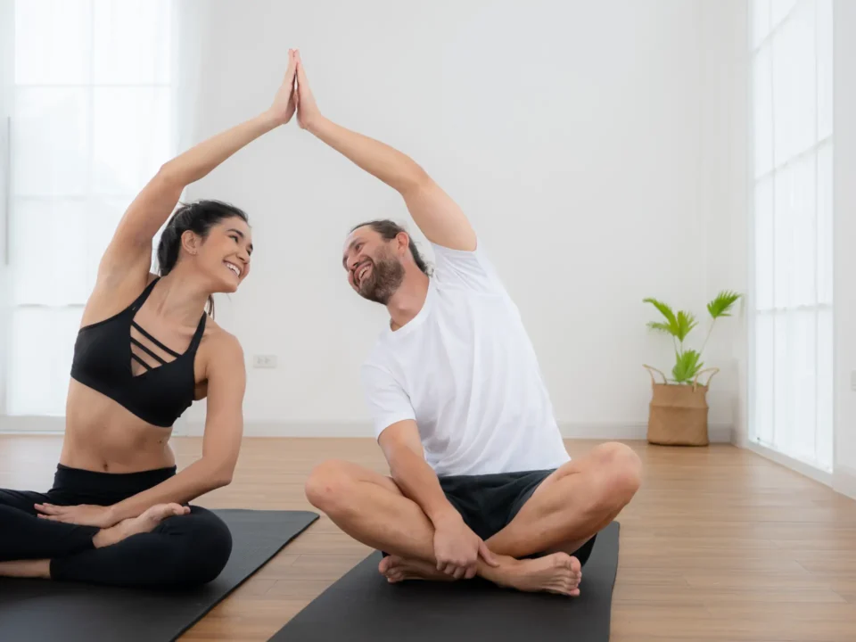 Couple practicing yoga at a yoga class